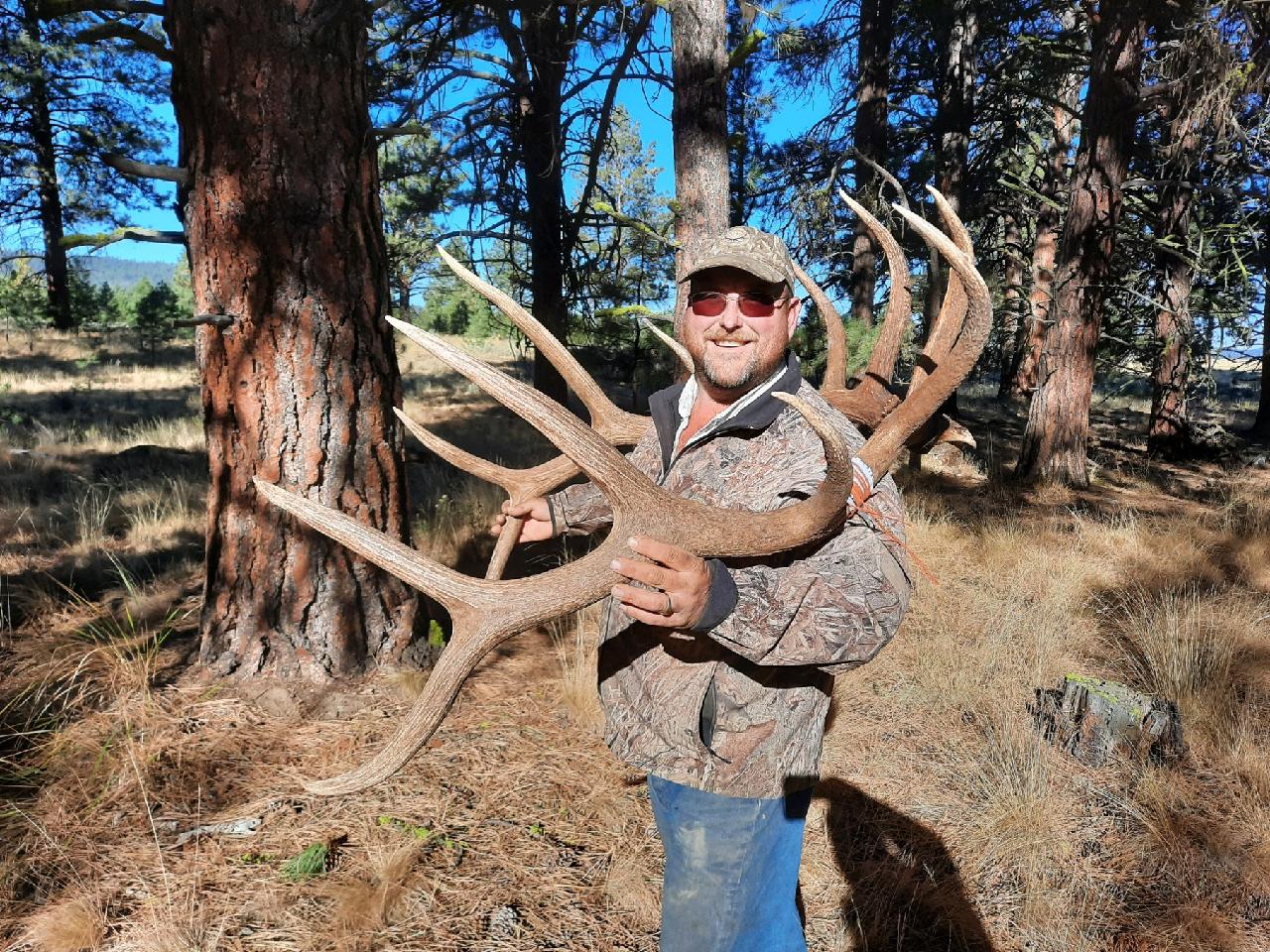 Dave Seida holding up large elk antler rack